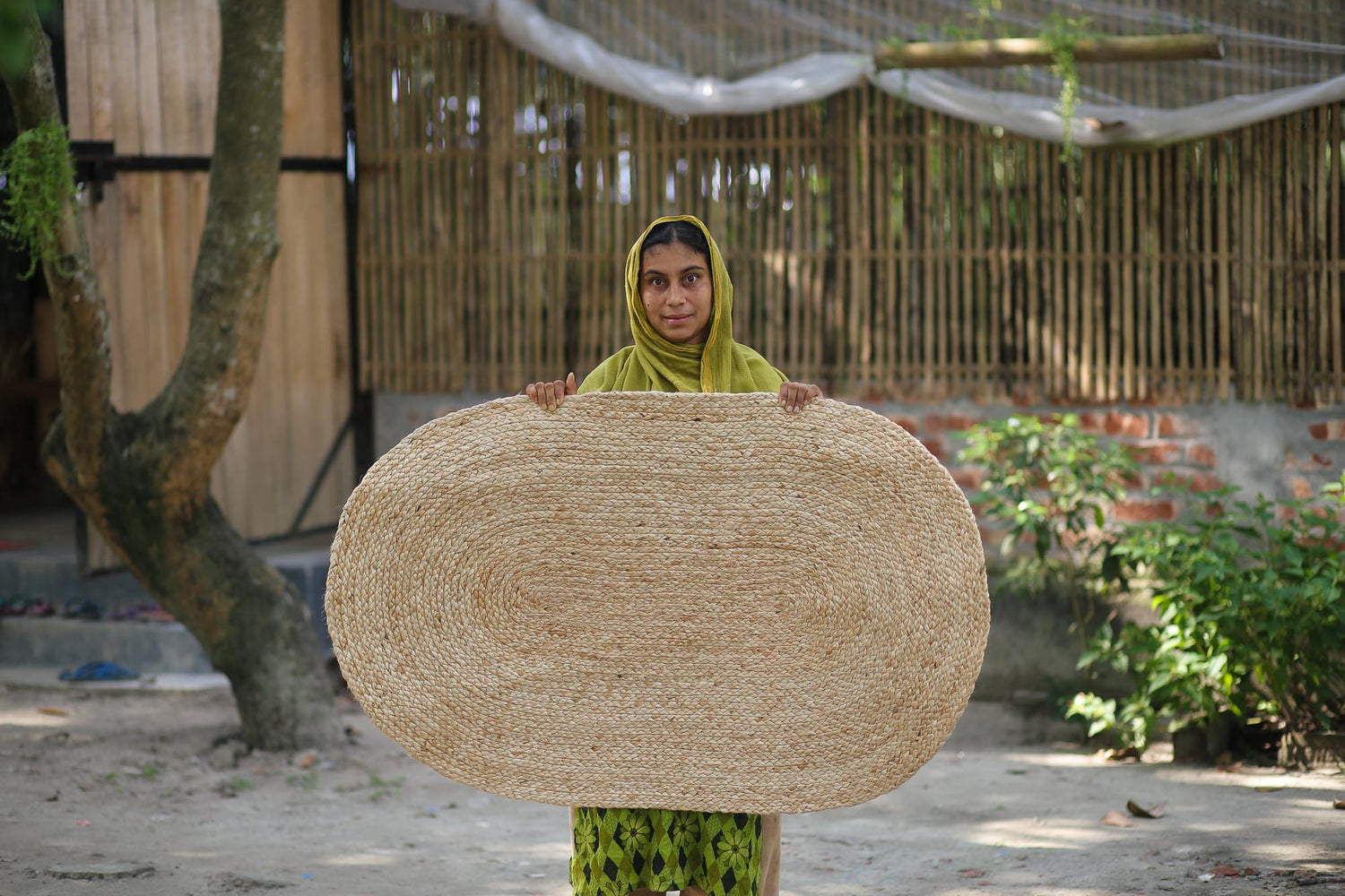 A Girl Holding Her Handmade Rug