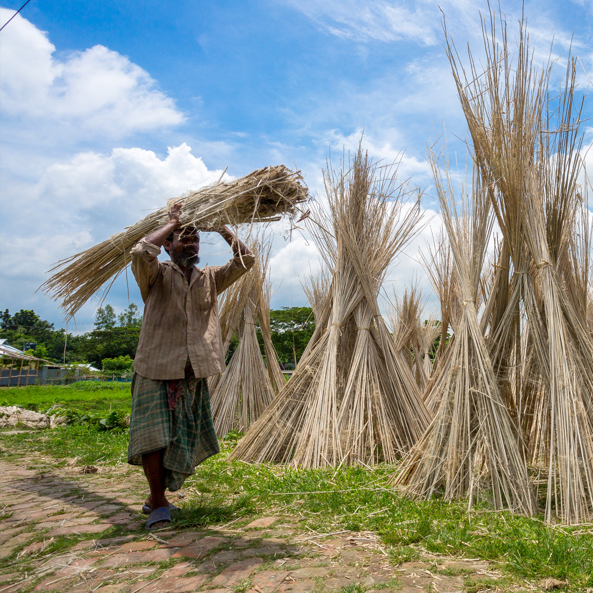 Man carrying jute on his head, showcasing traditional methods of transport